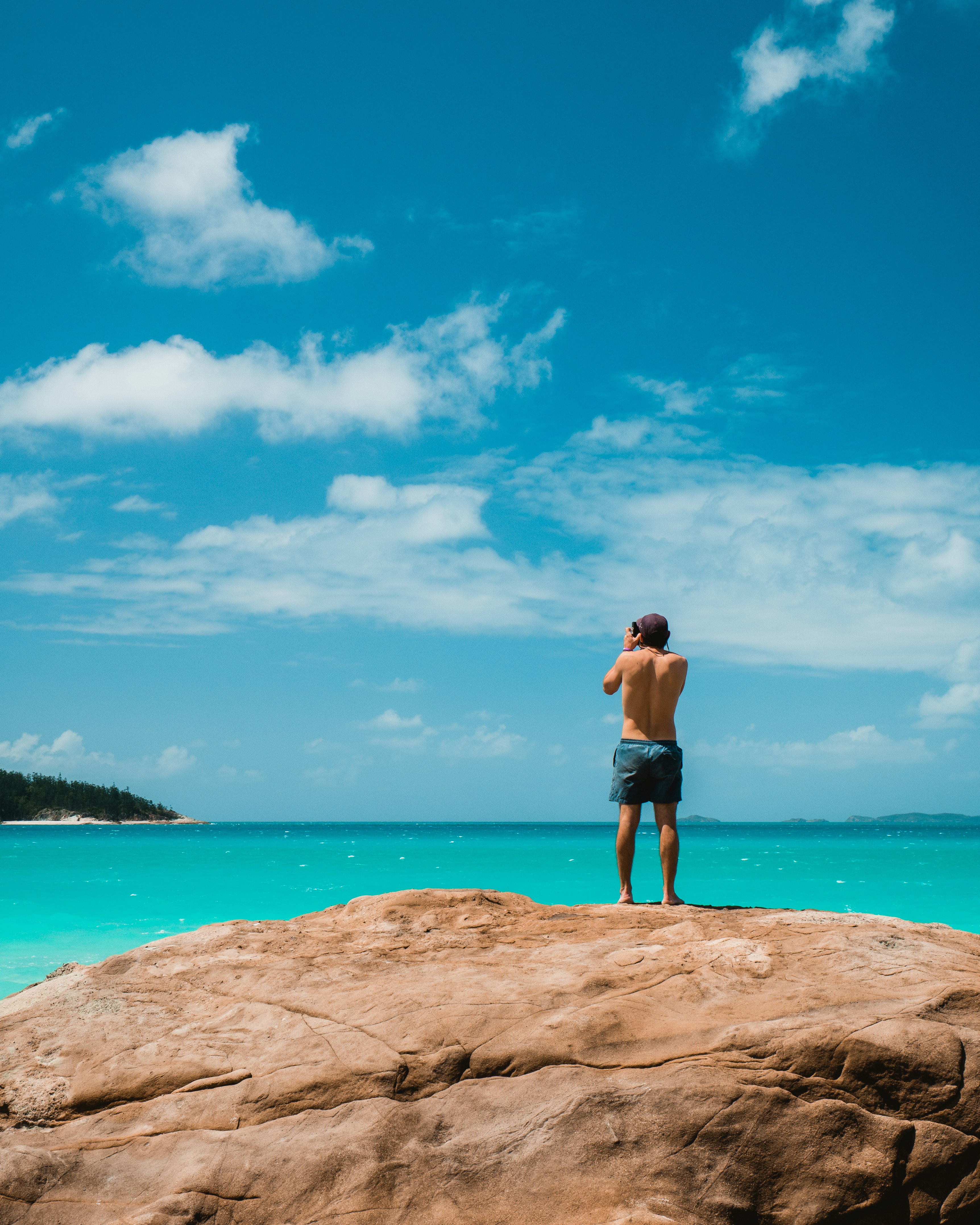 man standing on cliff during daytime